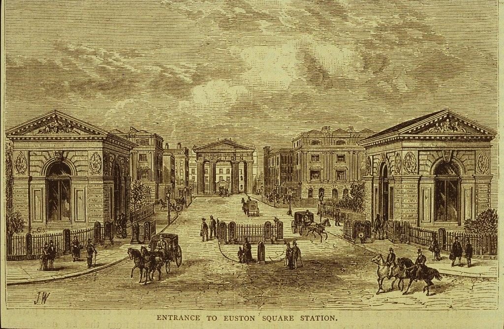 Attendees at meetings often long for the end of the debate but committee members of the National Railway Heritage Awards had a special reason for anticipating the end of the trust’s committee meeting on Wednesday 26 September as the date had been set for the official unveiling of the plaque made to Euston Tap Ltd for the restored windows in the two lodges at Euston. The plaque, presented at the annual ceremony held at Merchant Taylors’ Hall on 6 December 2017, recognised the project to restore the windows of the late 19th century lodges being given the Supporters Award. As was said at the ceremony ‘It has been a thoroughly worthwhile enterprise for which all involved can take great credit.’ 	One of the more entertaining facets of the event was the ‘curtain’ used to hide the plaque before its unveiling by Chris Smyth, from the Heritage Railway Association (one of the award’s sponsors) – this was one of the T-shirts normally worn by the staff behind the bar.